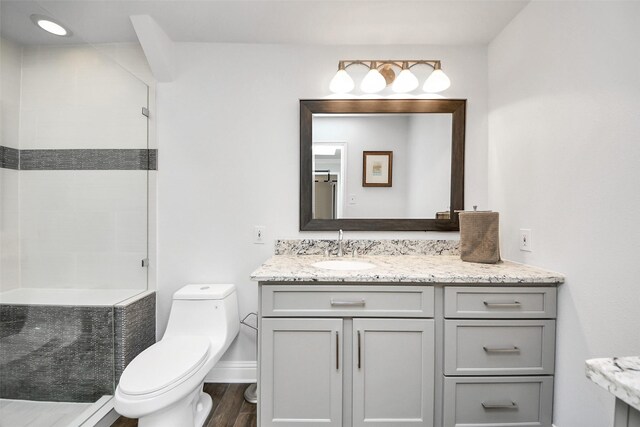 525 Rancho Bauer Dr, Houston, TX 77079 - full bath featuring toilet, tiled shower, wood finished floors, vanity, and baseboards