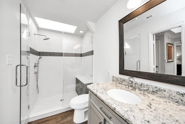 525 Rancho Bauer Dr, Houston, TX 77079 - full bath featuring a skylight, wood finished floors, a shower stall, toilet, and vanity