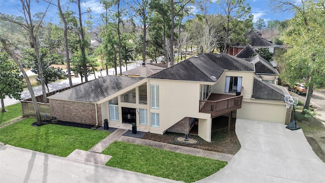 525 Rancho Bauer Dr, Houston, TX 77079 - view of front of property with a shingled roof, a front lawn, concrete driveway, a wooden deck, and an attached garage