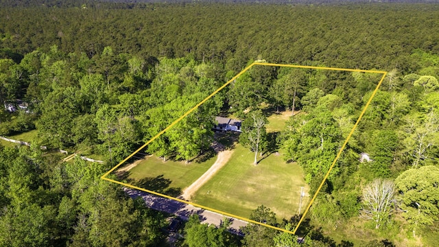 60 W Sierra Rd, Coldspring, TX 77331 - aerial view of property and surrounding area with a heavily wooded area and property parcel outlined
