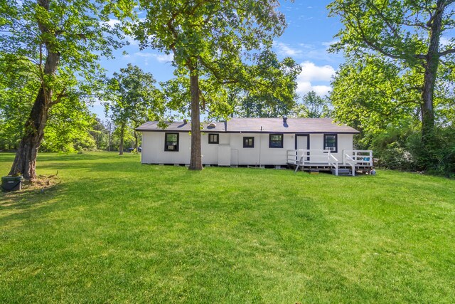 60 W Sierra Rd, Coldspring, TX 77331 - rear view of house with a wooden deck and a yard