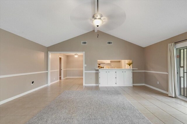 2003 Sieber Dr, Houston, TX 77017 - unfurnished living room featuring light tile patterned floors, a ceiling fan, vaulted ceiling, and baseboards