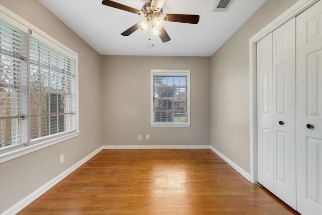 2003 Sieber Dr, Houston, TX 77017 - unfurnished bedroom featuring a closet, light wood-style flooring, baseboards, and a ceiling fan