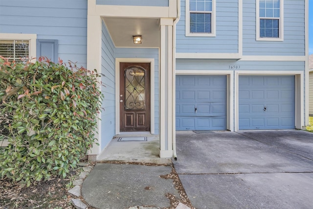 16503 Brightling Ln, Houston, TX 77090 - doorway to property featuring an attached garage and concrete driveway