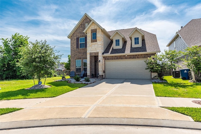 6303 Lemon Balm Ln, Crosby, TX 77532 - view of front of property with concrete driveway, a front lawn, stone siding, central AC, and roof with shingles