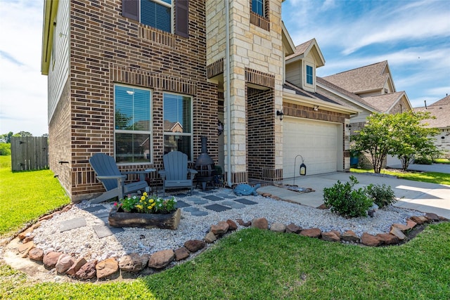 6303 Lemon Balm Ln, Crosby, TX 77532 - view of exterior entry featuring a garage, concrete driveway, brick siding, and a shingled roof