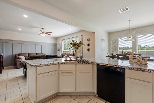 6303 Lemon Balm Ln, Crosby, TX 77532 - kitchen featuring dishwasher, a sink, open floor plan, light stone counters, and light tile patterned floors
