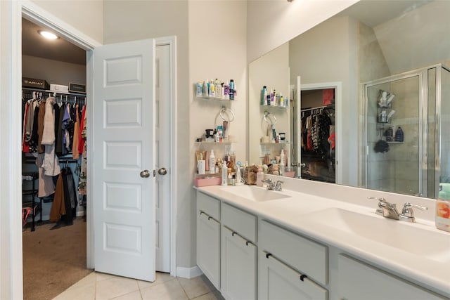 6303 Lemon Balm Ln, Crosby, TX 77532 - bathroom featuring a stall shower, tile patterned flooring, double vanity, and a walk in closet