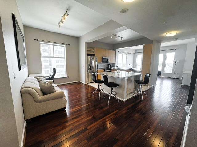 3505 Sage Rd Unit 602, Houston, TX 77056 - kitchen featuring appliances with stainless steel finishes, track lighting, dark wood-type flooring, a kitchen bar, and open floor plan