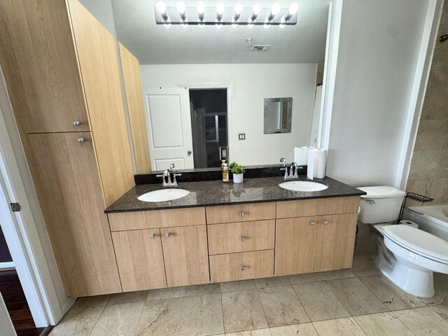 3505 Sage Rd Unit 602, Houston, TX 77056 - bathroom featuring toilet, double vanity, and marble look tile flooring