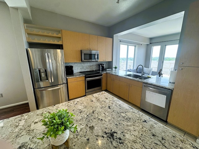 3505 Sage Rd Unit 602, Houston, TX 77056 - kitchen with appliances with stainless steel finishes, a sink, tasteful backsplash, light stone counters, and open shelves