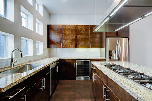 2356 Commerce, Houston, TX 77003 - kitchen with appliances with stainless steel finishes, beverage cooler, dark wood-style flooring, light stone countertops, and tasteful backsplash