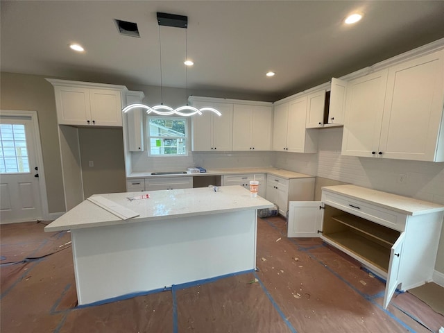 6322 Sayers St, Houston, TX 77026 - kitchen with a center island, tasteful backsplash, white cabinets, and recessed lighting