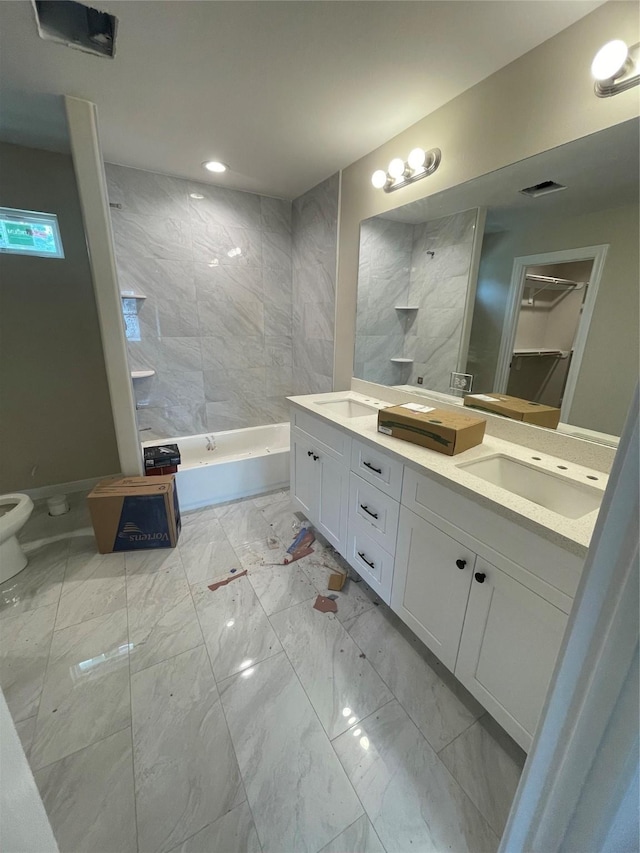 6322 Sayers St, Houston, TX 77026 - bathroom with marble finish flooring, double vanity, toilet, and recessed lighting