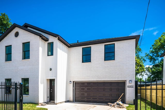 6322 Sayers St, Houston, TX 77026 - view of front of home featuring brick siding, an attached garage, and driveway
