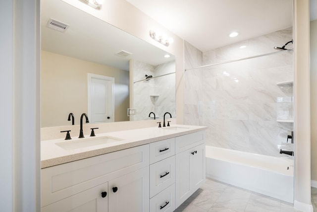 6322 Sayers St, Houston, TX 77026 - full bathroom featuring double vanity, bathing tub / shower combination, and marble look tile flooring