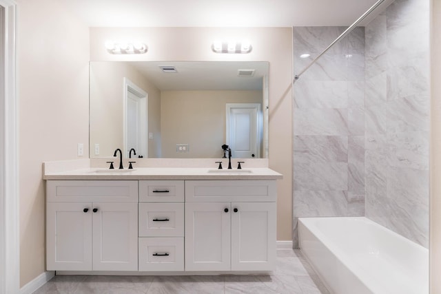 6322 Sayers St, Houston, TX 77026 - bathroom with double vanity,  shower combination, and marble look tiles