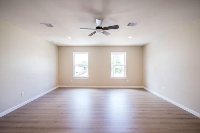 6322 Sayers St, Houston, TX 77026 - empty room with a ceiling fan, dark wood-style floors, and recessed lighting