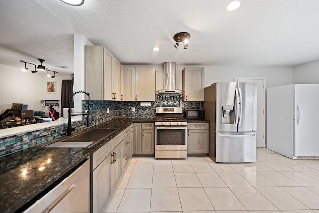 28707 Stapleford St, Spring, TX 77386 - kitchen featuring stainless steel appliances, wall chimney range hood, a sink, decorative backsplash, and dark stone counters