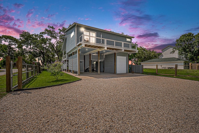 817 Bryan Ave, Seabrook, TX 77586 - rear view of property featuring gravel driveway, an attached garage, a carport, and a balcony