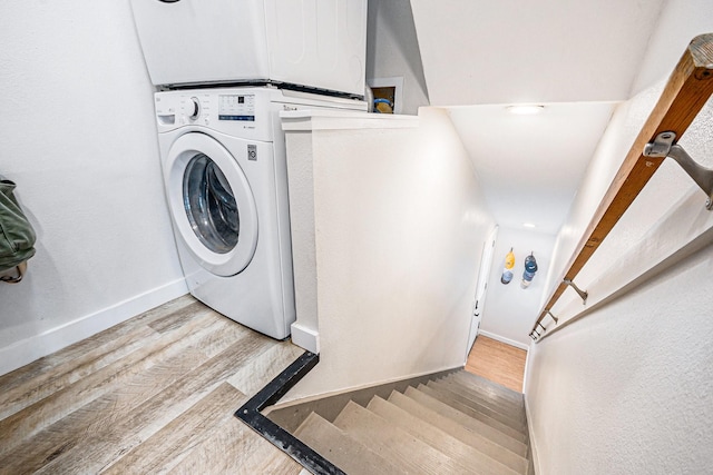 817 Bryan Ave, Seabrook, TX 77586 - laundry room with wood finished floors, baseboards, and stacked washer / dryer