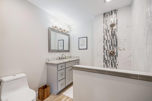 817 Bryan Ave, Seabrook, TX 77586 - bathroom with vanity, a walk in shower, wood finished floors, and toilet