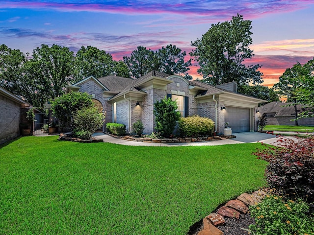 2815 Halton Ct, Kingwood, TX 77345 - view of front facade with a garage, a yard, concrete driveway, brick siding, and roof with shingles