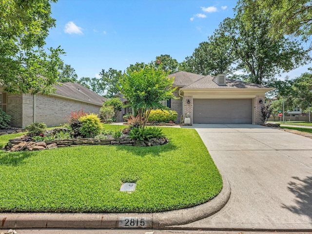 2815 Halton Ct, Kingwood, TX 77345 - view of front facade with brick siding, an attached garage, driveway, and a front lawn