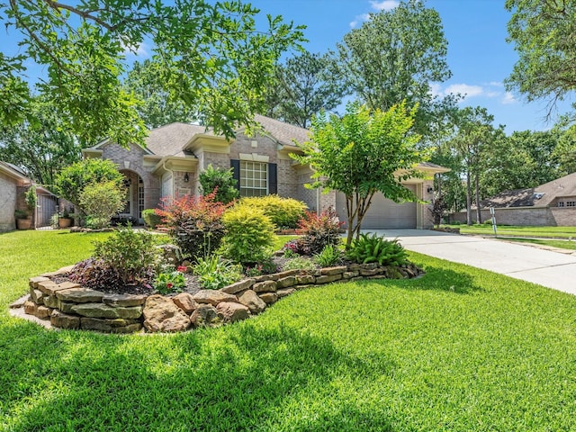 2815 Halton Ct, Kingwood, TX 77345 - view of front of home featuring concrete driveway, a front lawn, a garage, brick siding, and roof with shingles