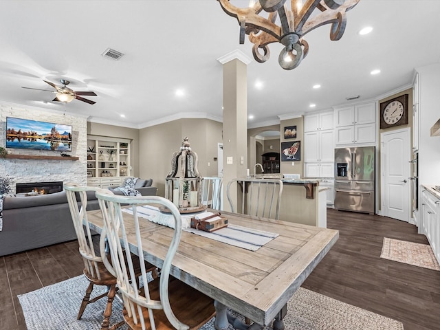 2815 Halton Ct, Kingwood, TX 77345 - dining space with arched walkways, a ceiling fan, ornamental molding, recessed lighting, and dark wood-type flooring