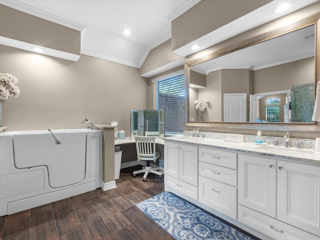 2815 Halton Ct, Kingwood, TX 77345 - bathroom with crown molding, wood finished floors, double vanity, a tub to relax in, and lofted ceiling
