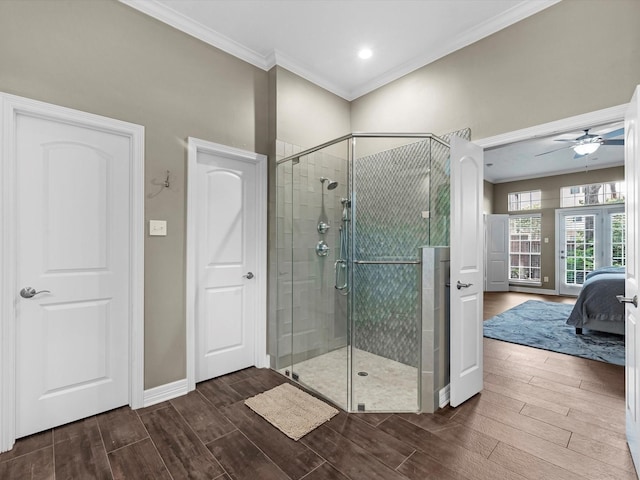 2815 Halton Ct, Kingwood, TX 77345 - full bath featuring crown molding, wood finished floors, ensuite bath, a shower stall, and a ceiling fan