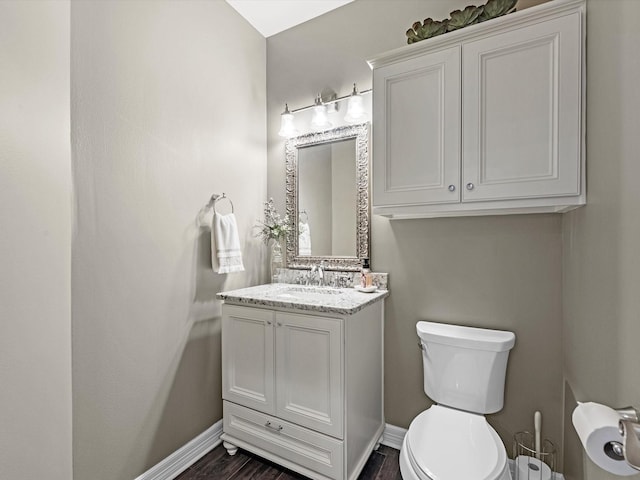 2815 Halton Ct, Kingwood, TX 77345 - bathroom featuring toilet, baseboards, vanity, and wood finished floors