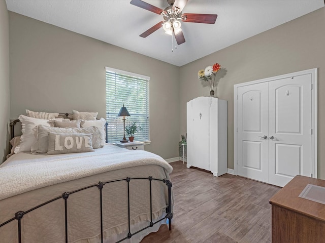 2815 Halton Ct, Kingwood, TX 77345 - bedroom featuring wood finished floors, baseboards, a ceiling fan, and a closet