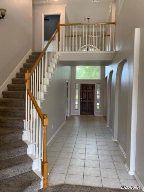 17523 Ginger Fields Ln, Tomball, TX 77377 - foyer with tile patterned floors, a towering ceiling, stairs, and baseboards