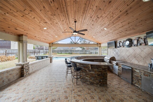 605 Foster Dr, Richmond, TX 77469 - view of patio / terrace featuring exterior kitchen, a fenced backyard, and a ceiling fan