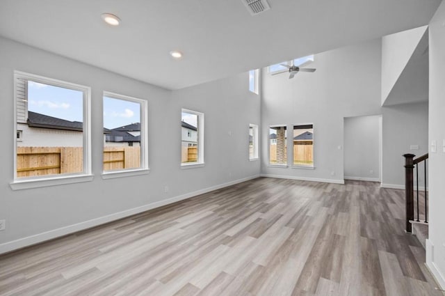 8802 Cecil Garden Ln, Cypress, TX 77433 - unfurnished living room featuring plenty of natural light, wood finished floors, a ceiling fan, baseboards, and recessed lighting