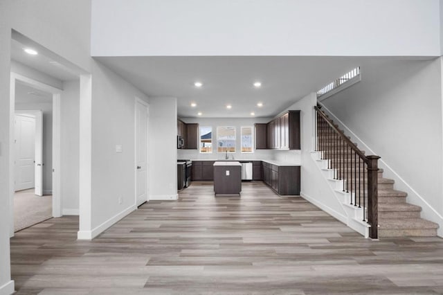 8802 Cecil Garden Ln, Cypress, TX 77433 - kitchen featuring light wood-style flooring, recessed lighting, dark brown cabinets, and baseboards