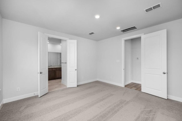 8802 Cecil Garden Ln, Cypress, TX 77433 - unfurnished bedroom with light colored carpet, baseboards, recessed lighting, and connected bathroom