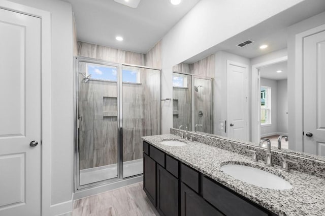 8802 Cecil Garden Ln, Cypress, TX 77433 - bathroom featuring double vanity, a stall shower, recessed lighting, and baseboards
