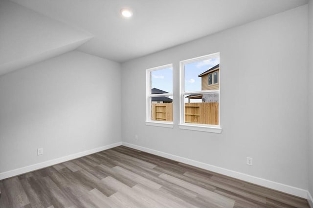 8802 Cecil Garden Ln, Cypress, TX 77433 - additional living space featuring wood finished floors, vaulted ceiling, baseboards, and recessed lighting