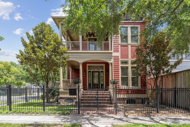 2024 Singleton St, Houston, TX 77008 - view of front of house featuring a balcony, a fenced front yard, covered porch, and a gate