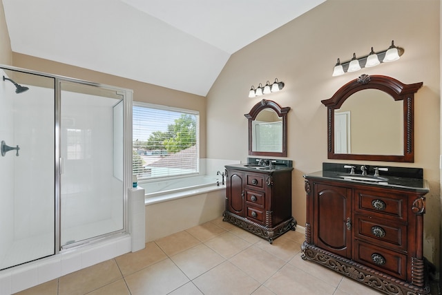 19042 Keyturn Ln, Humble, TX 77346 - bathroom featuring a stall shower, vaulted ceiling, a garden tub, two vanities, and tile patterned flooring
