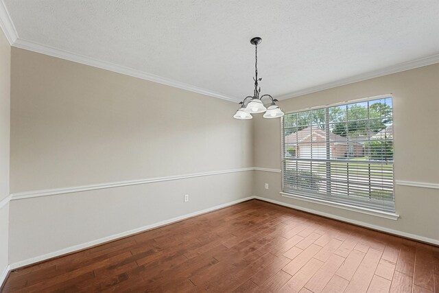 19042 Keyturn Ln, Humble, TX 77346 - empty room with a chandelier, dark wood-style flooring, baseboards, and ornamental molding