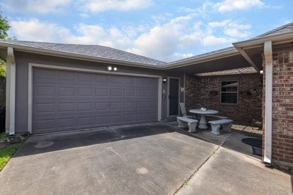 3314 Park Meadows Ave, Deer Park, TX 77536 - view of front of house with concrete driveway, a garage, and brick siding