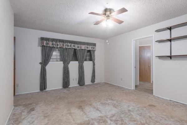 3314 Park Meadows Ave, Deer Park, TX 77536 - empty room with a textured ceiling, carpet flooring, a ceiling fan, and baseboards