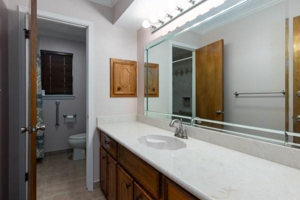 3314 Park Meadows Ave, Deer Park, TX 77536 - bathroom with toilet, vanity, tile patterned floors, crown molding, and baseboards