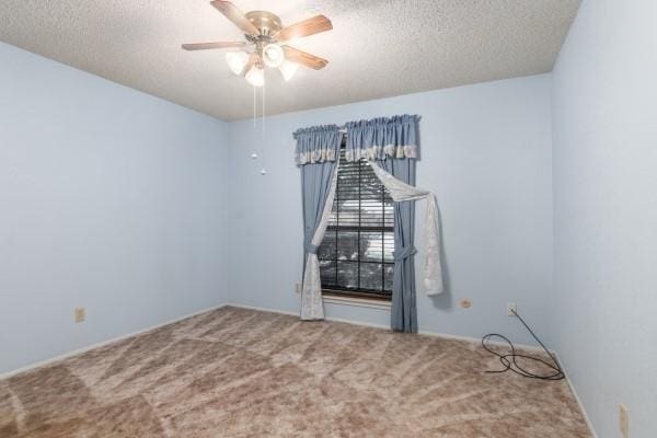 3314 Park Meadows Ave, Deer Park, TX 77536 - empty room with carpet flooring, a textured ceiling, and a ceiling fan