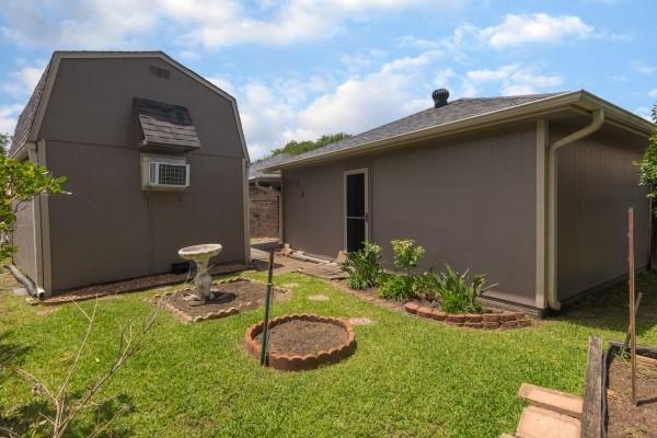 3314 Park Meadows Ave, Deer Park, TX 77536 - view of side of property featuring a lawn and an outbuilding