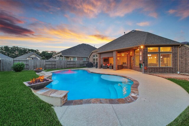 15715 Holloway Creek Ct, Houston, TX 77044 - pool at dusk featuring a fire pit and a patio